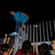 A protester climbs over a fence as she leaves after hundreds stormed into a restricted area at the government headquarters, after a rally ahead of the October 1 "Occupy Central" civil disobedience movement in Hong Kong September 26, 2014.